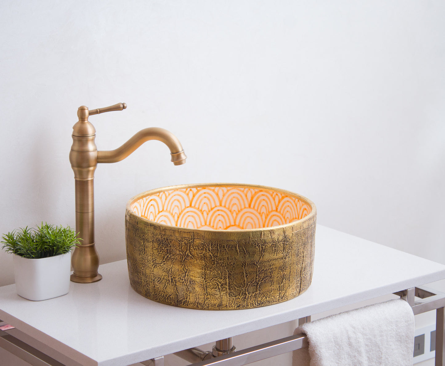 Moroccan ceramic basin installed on white bathroom vanity with brass faucet and decorative plant showing real-world application