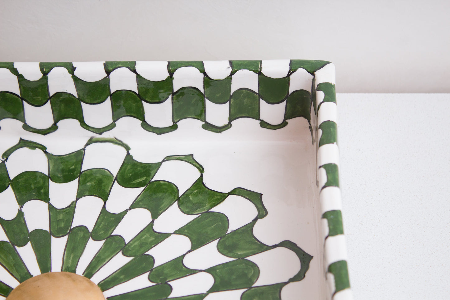 Detailed view of corner section showing intricate green and white geometric pattern and artisan ceramic craftsmanship