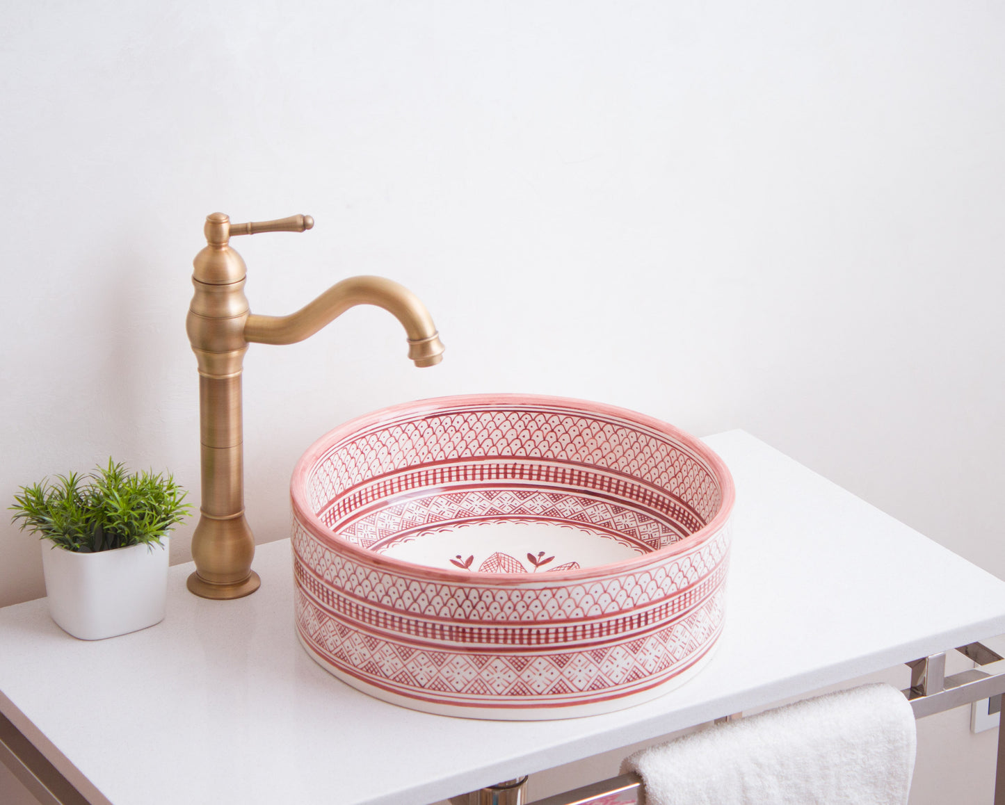 Handmade ceramic vessel sink positioned on contemporary bathroom counter with brass faucet in modern bathroom setting