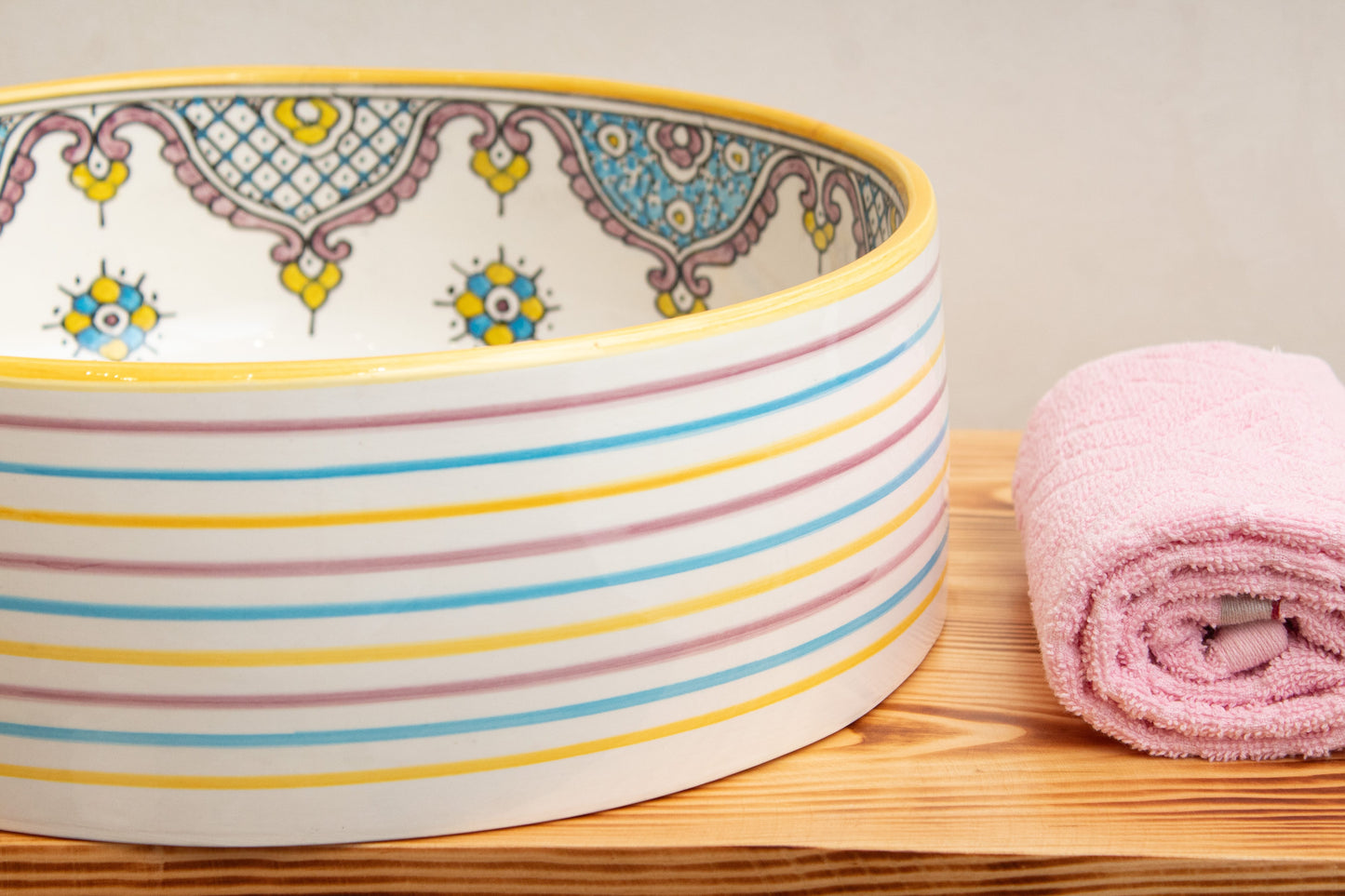 close up of Moroccan ceramic sink rim detail displaying hand-painted geometric patterns and decorative motifs