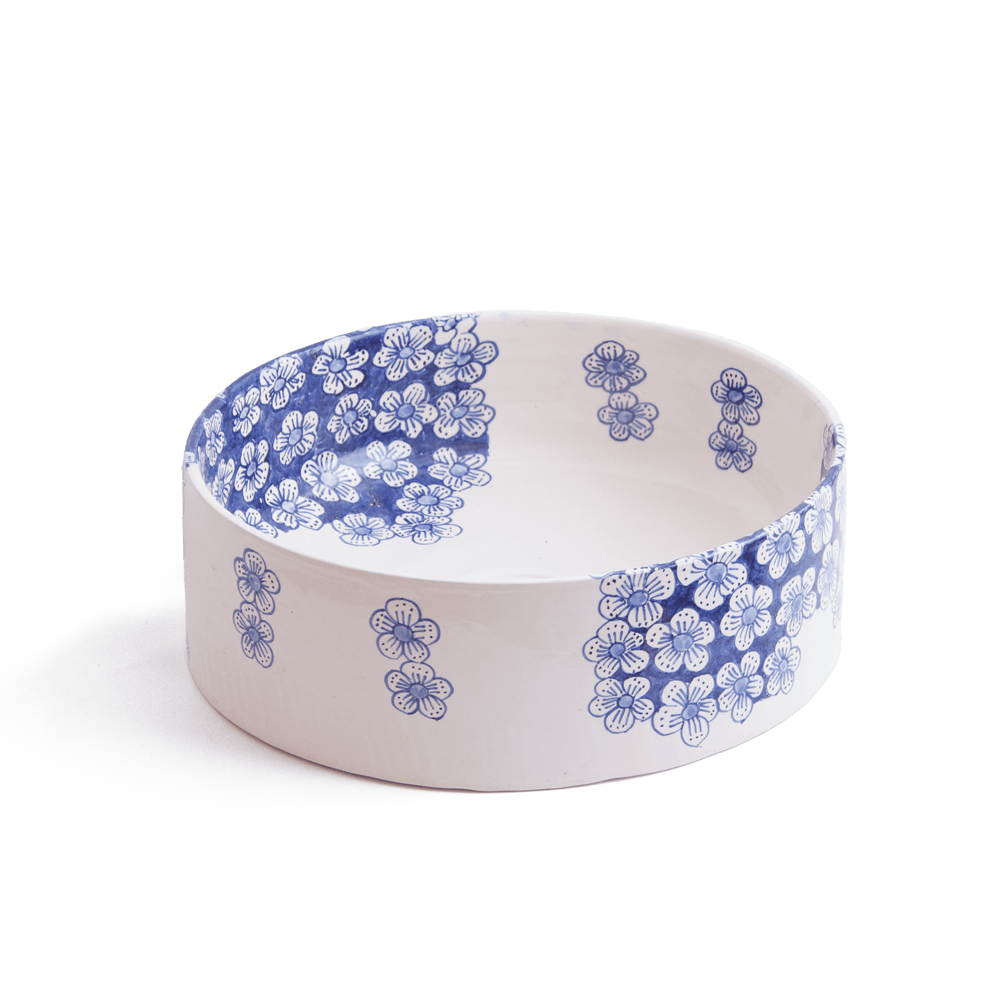 Three-quarter perspective view of ceramic vessel sink with blue flower motifs on white background showing complete bowl shape and decorative pattern