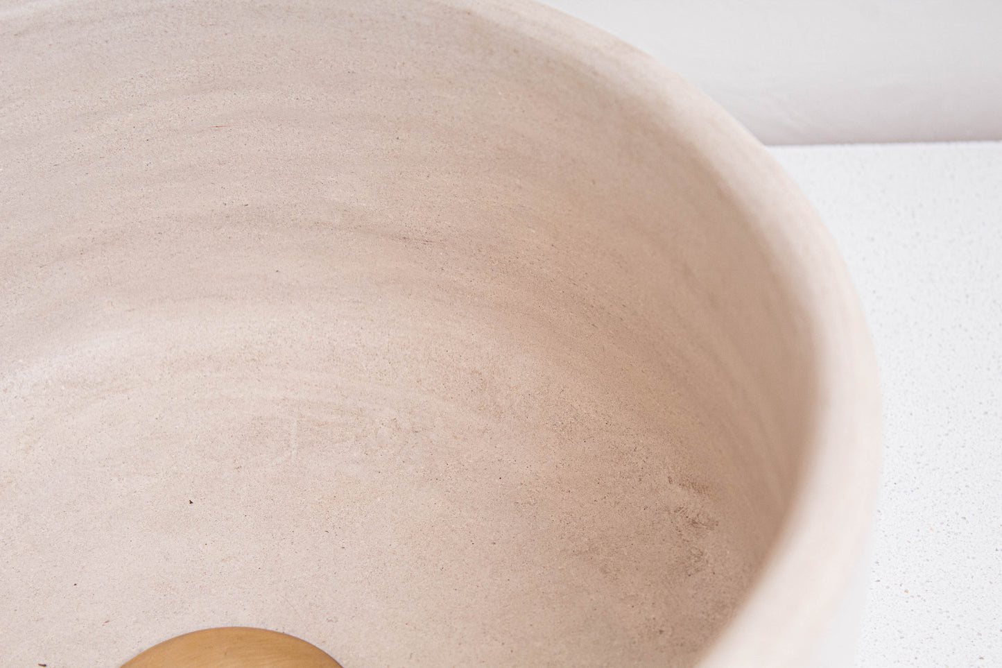 Detailed view of natural beige ceramic texture and smooth tadelakt finish on handmade Moroccan vessel sink