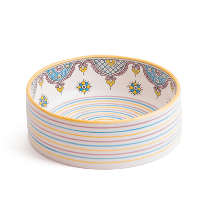 Artisanal ceramic bathroom sink showing interior geometric patterns and striped base design
