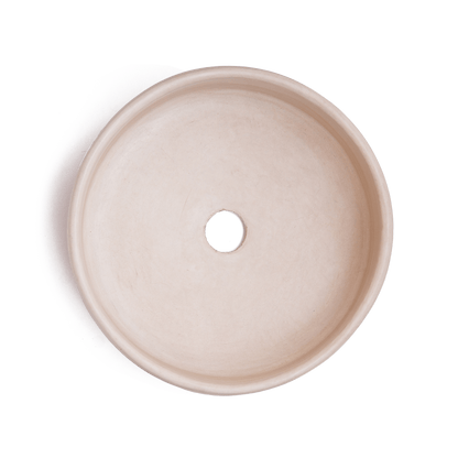 Top-down view of vessel sink interior displaying smooth cream-colored ceramic surface