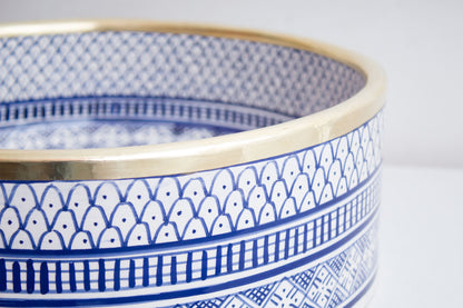Macro close-up detail of intricate blue and white geometric pattern bands around the exterior rim of handcrafted ceramic basin