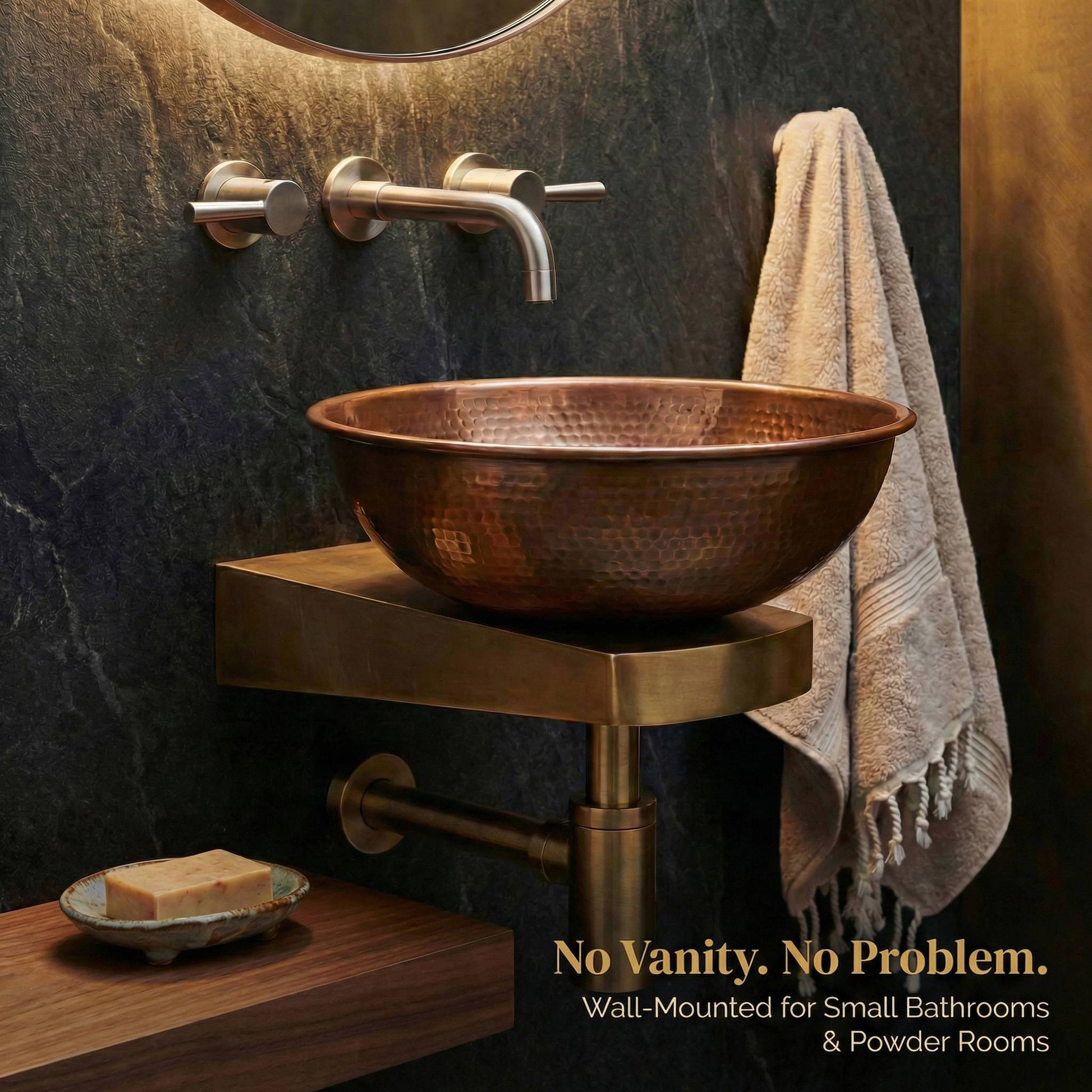 Wall-mounted brass sink support bracket holding hammered copper vessel sink with brushed nickel faucet in dark bathroom