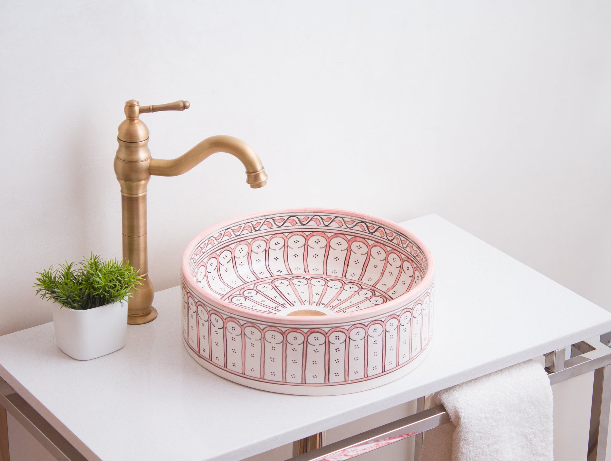 Handmade ceramic vessel sink positioned on contemporary bathroom counter with brass faucet in modern bathroom setting