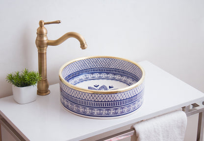 Handmade ceramic vessel sink positioned on contemporary bathroom counter with brass faucet in modern bathroom setting