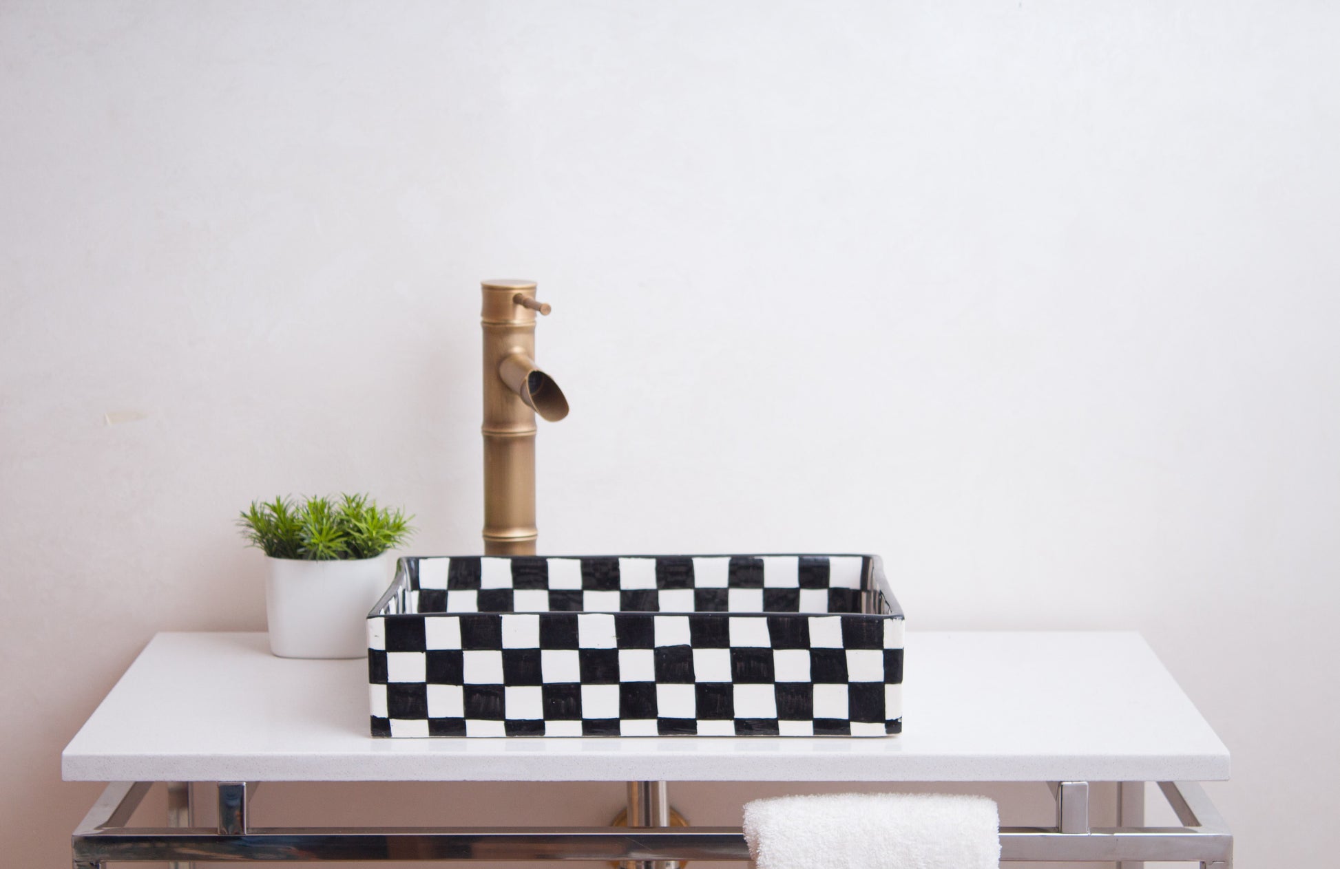 Front lifestyle view of checkerboard vessel sink with brass faucet in contemporary bathroom