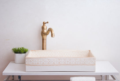 Front lifestyle view of beige vessel sink with brass faucet in contemporary bathroom setting