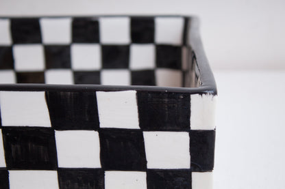 Close-up detail of black and white checkered pattern on rectangular basin rim and exterior