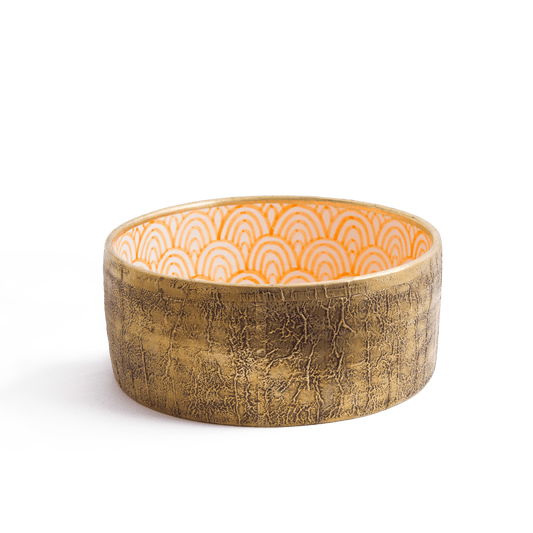 Handcrafted ceramic vessel sink with textured bronze exterior and orange geometric pattern interior displayed at three-quarter angle