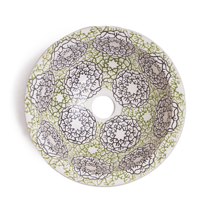 Interior view of handcrafted ceramic basin displaying intricate green and brown geometric mandala patterns