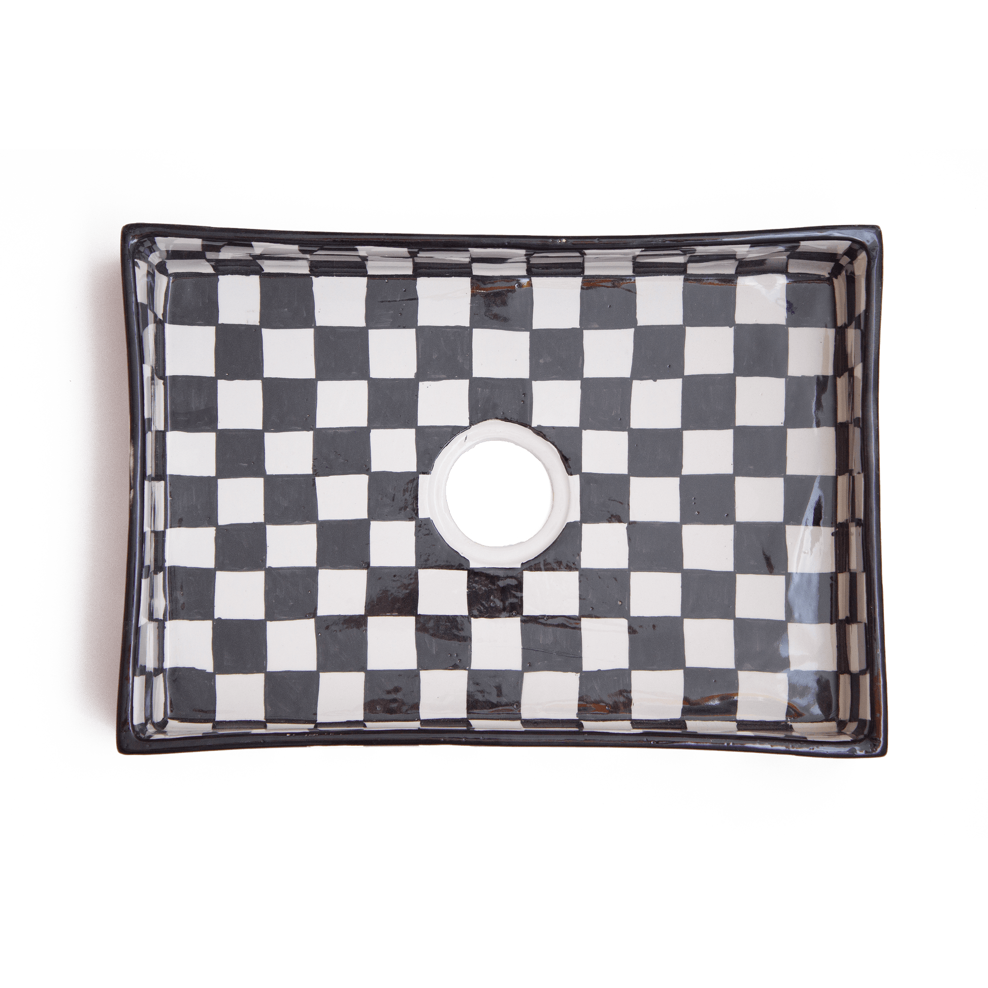 Top-down view of rectangular ceramic basin displaying interior checkerboard pattern