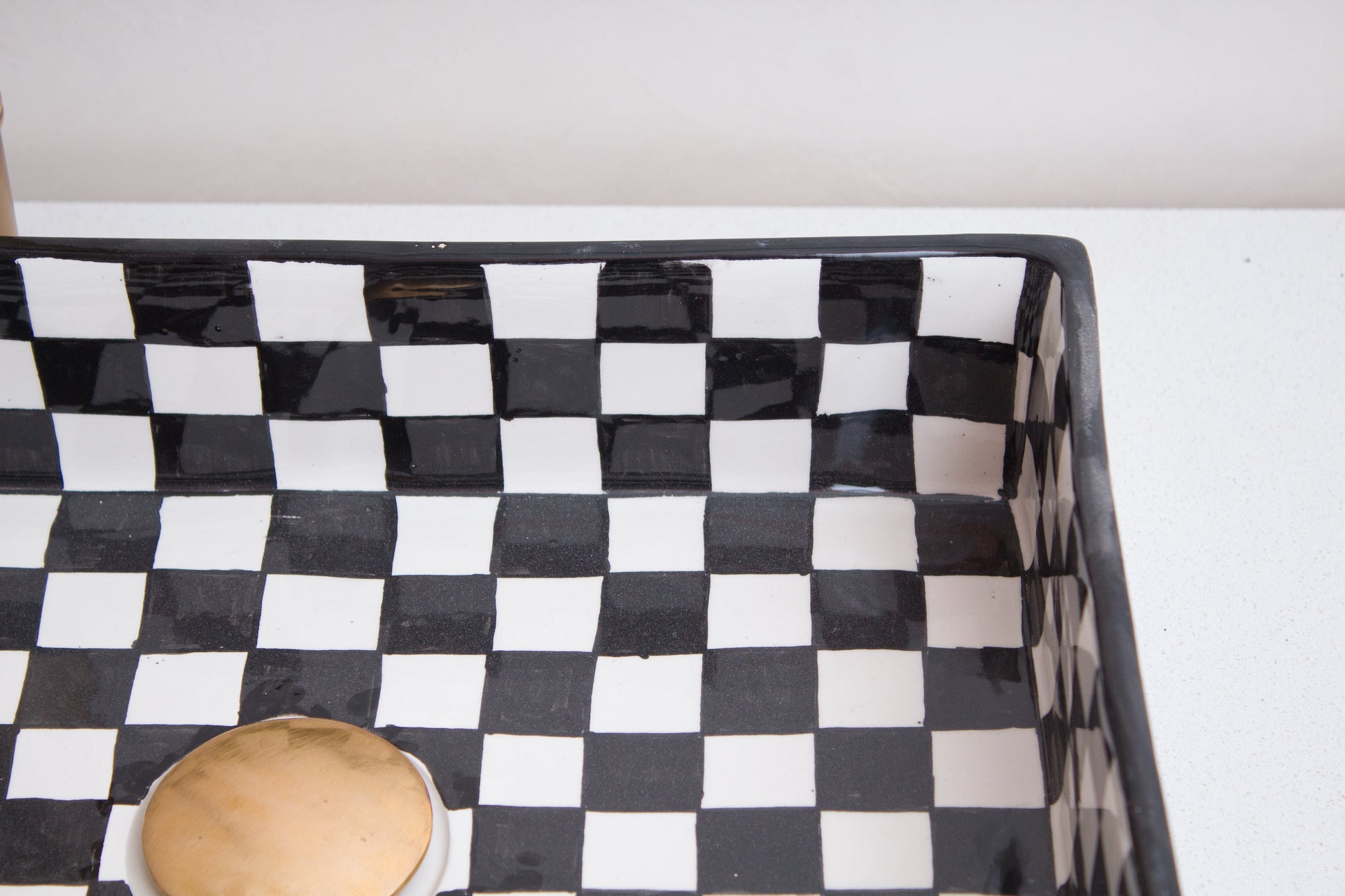 Detailed view of interior checkerboard design showing geometric black and white squares