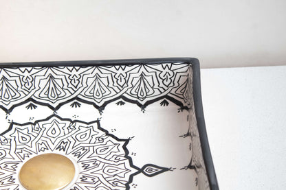 Close-up view of the intricate black and white geometric border pattern on a handcrafted Moroccan ceramic vessel sink with contrasting edge detail