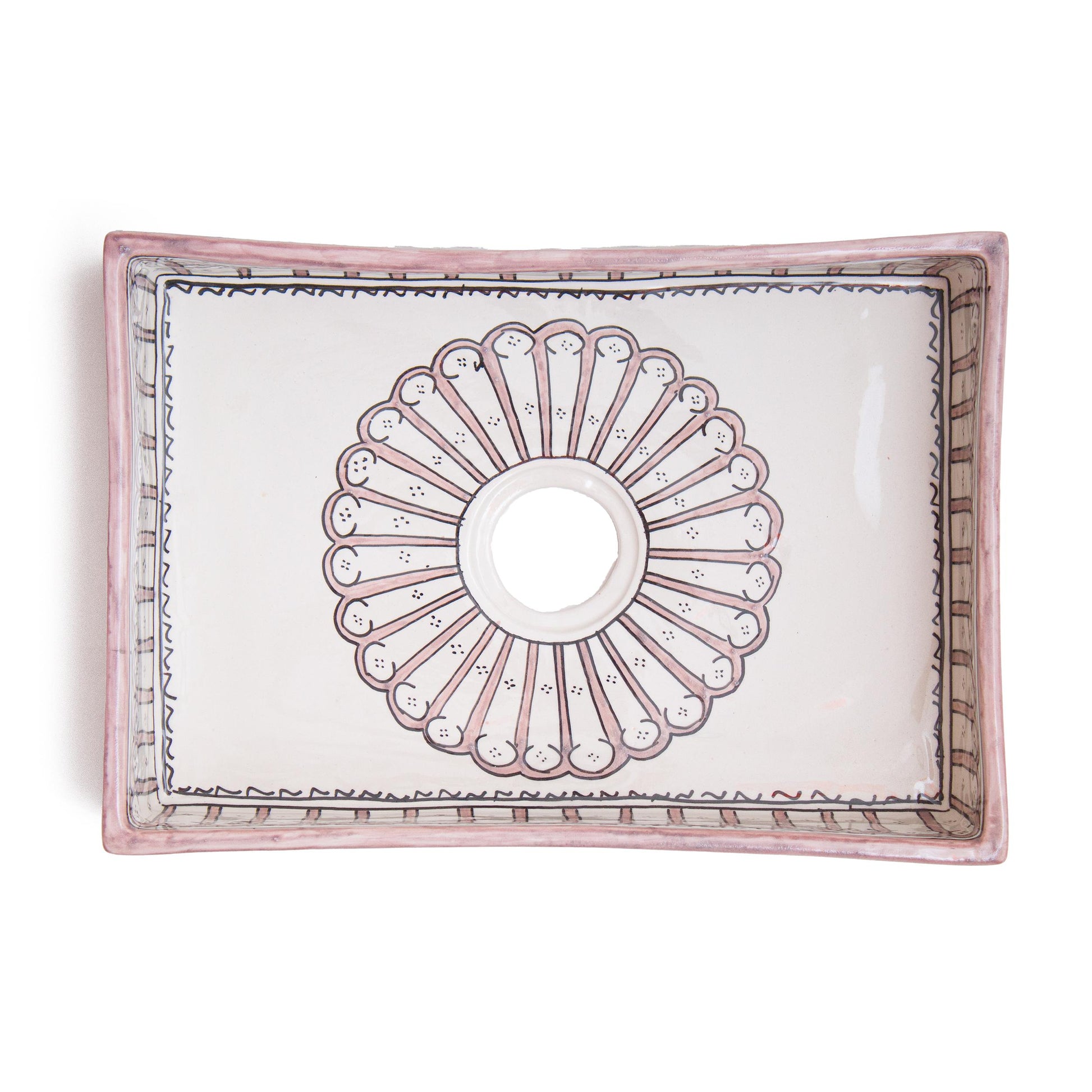 Top-down view revealing complete interior sunburst medallion pattern design of rectangular ceramic bathroom sink with centered drain opening