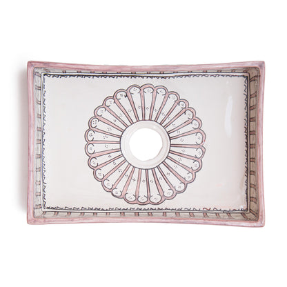 Top-down view revealing complete interior sunburst medallion pattern design of rectangular ceramic bathroom sink with centered drain opening