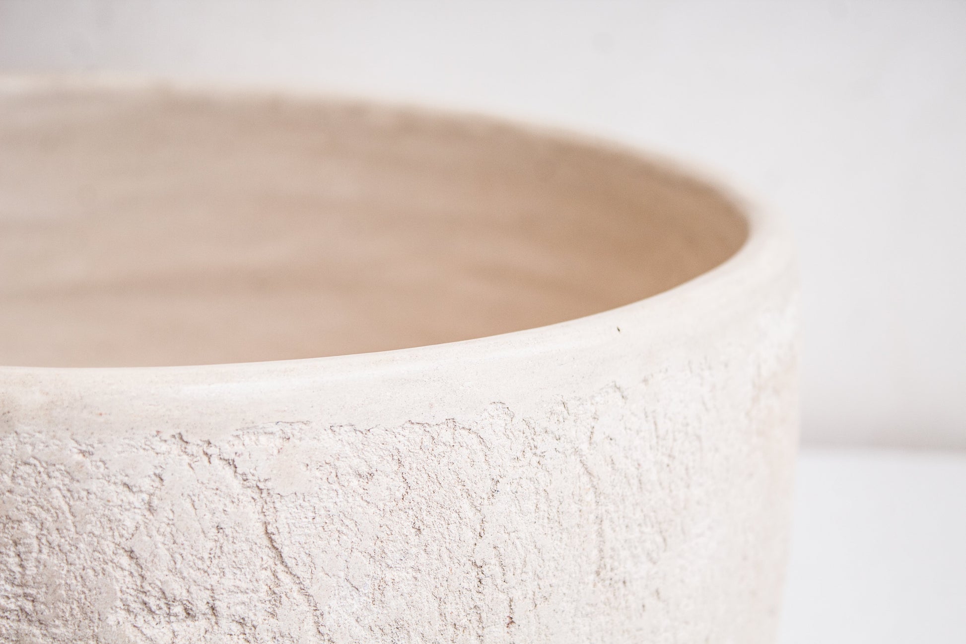 Close-up detail of organic textured rim showing handcrafted ceramic surface finish