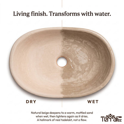 Top view of the beige tadelakt sink, half dry and half wet, showing how the beige deepens to a mottled sand when wet and lightens again as it dries