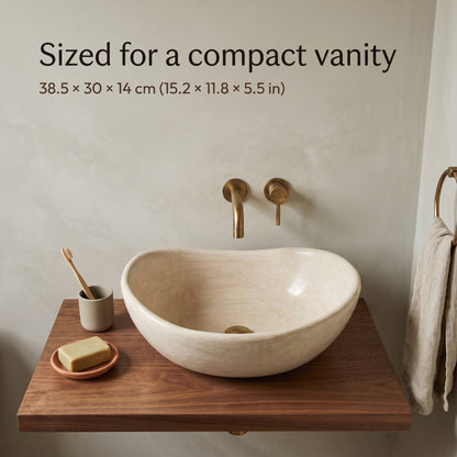 Small beige tadelakt vessel sink, 38.5 x 30 x 14 cm (15.2 x 11.8 x 5.5 in), on a compact walnut floating shelf with a brass wall faucet and gray plaster wall