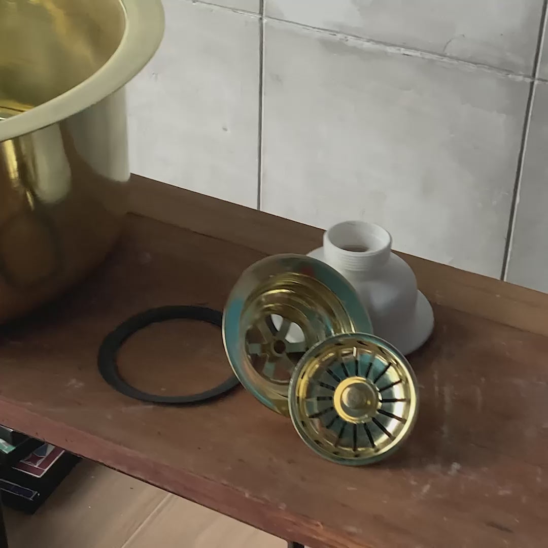Video showcasing a handcrafted round brass bar sink from multiple angles with a close-up of the included solid brass drain assembly and strainer by TerraFez