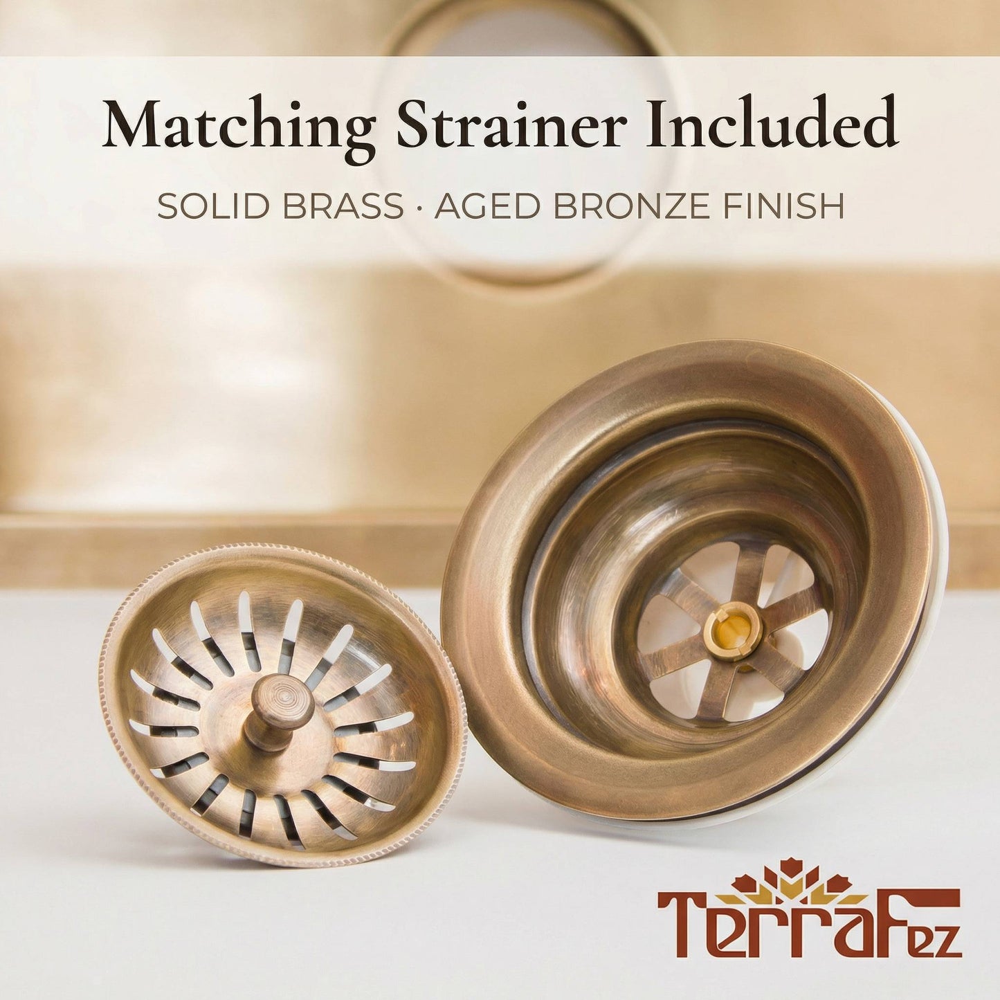 Close-up of the included solid brass sink strainer drain assembly in aged bronze finish, showing the removable strainer basket and drain flange, with the brass undermount sink visible in the background.