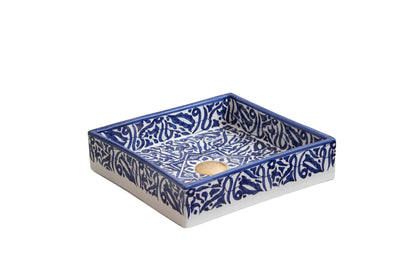 Three-quarter view of handmade ceramic bathroom sink with navy blue Islamic-inspired pattern