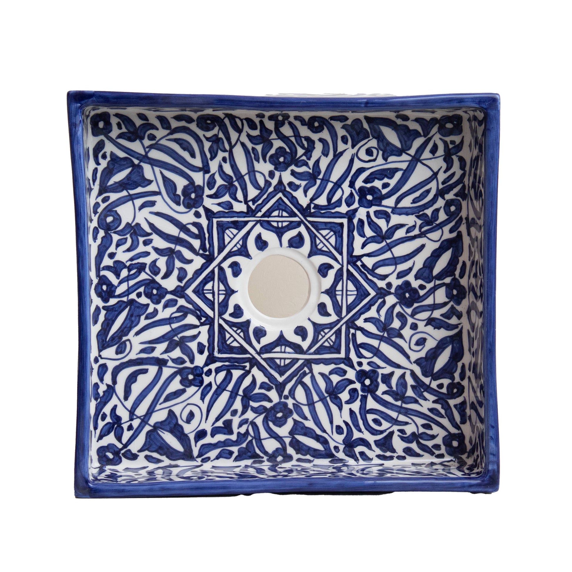Overhead view of rectangular vessel sink showing navy blue geometric tile pattern and cream interior