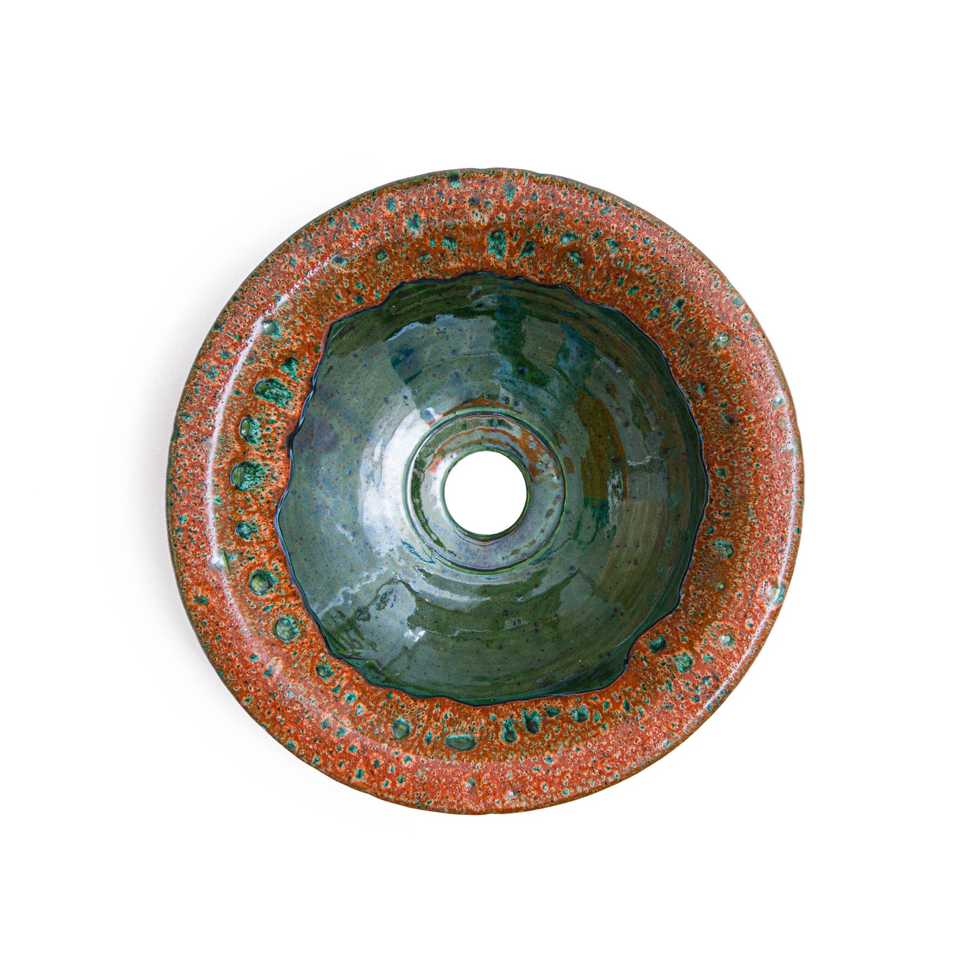 Interior view of handmade ceramic vessel sink showing teal glaze and organic bowl shape