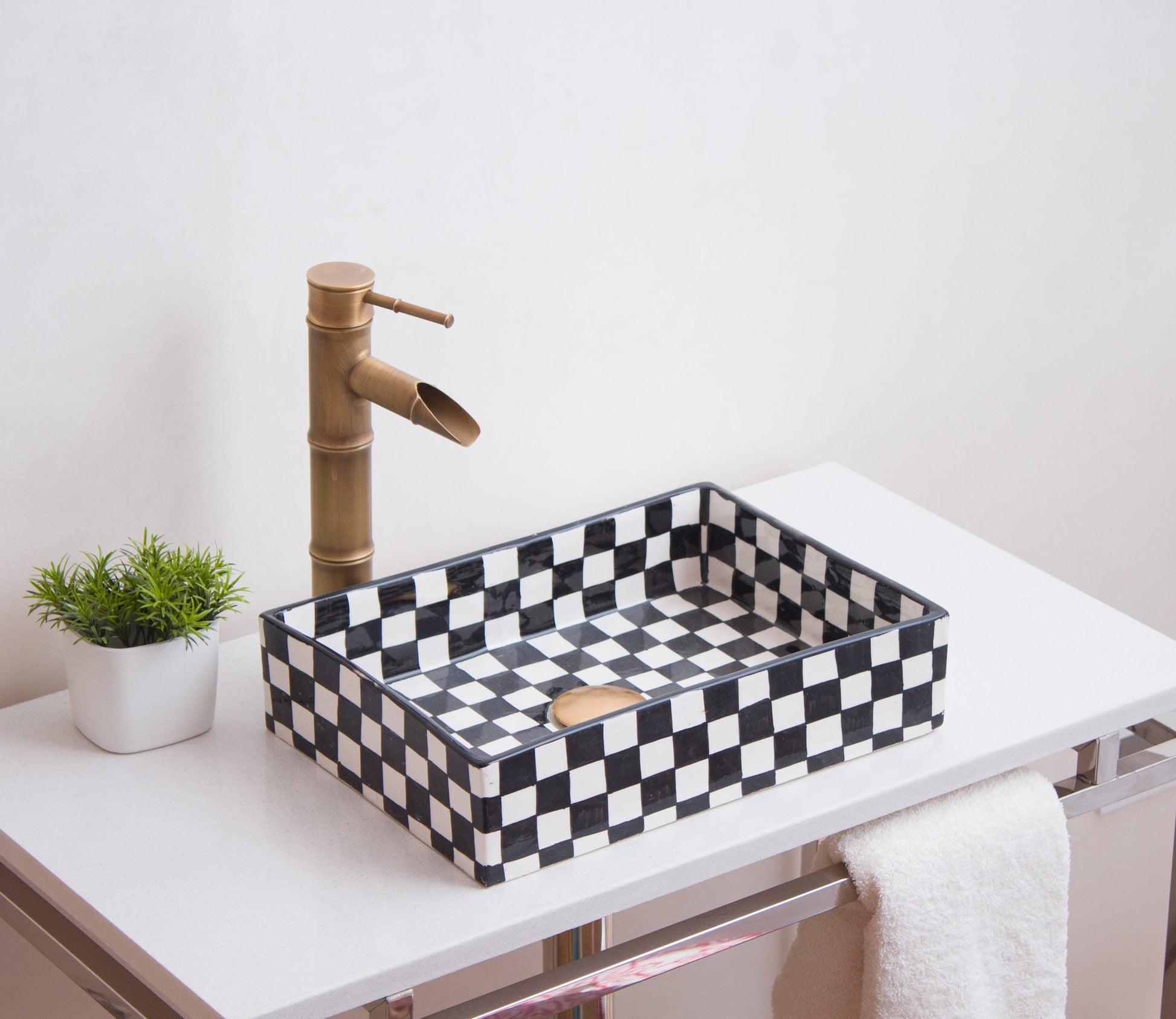 Handcrafted rectangular sink photographed from side angle showcasing checkerboard pattern