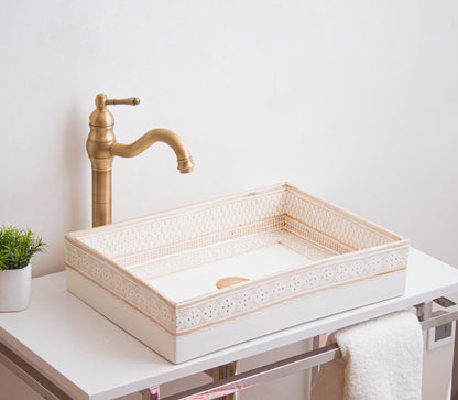 Handcrafted rectangular sink photographed from side angle showcasing detailed beige border patterns